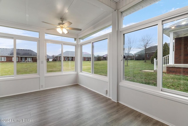 unfurnished sunroom featuring ceiling fan