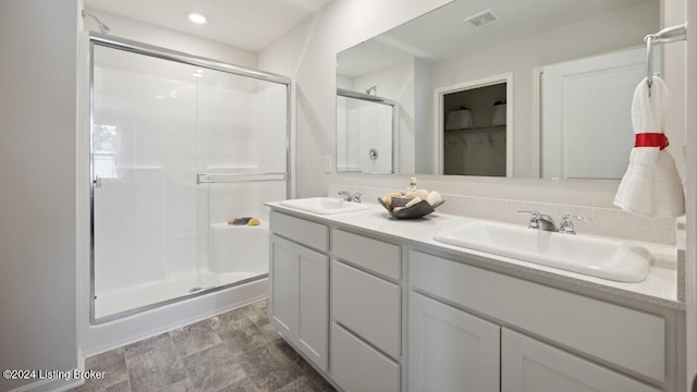 bathroom with vanity and a shower with shower door