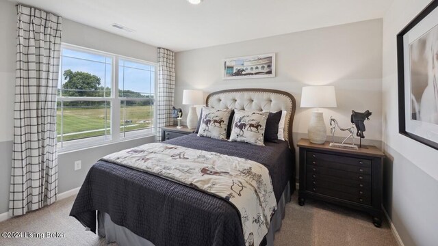 bedroom featuring light colored carpet