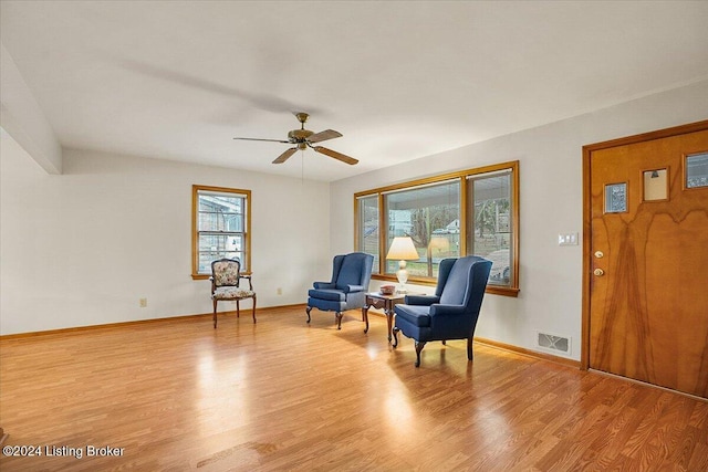 sitting room featuring ceiling fan and light hardwood / wood-style flooring