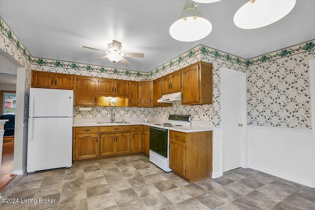 kitchen featuring pendant lighting, ceiling fan, white appliances, and sink