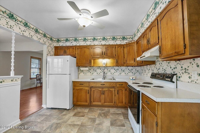 kitchen with white appliances, ceiling fan, and sink