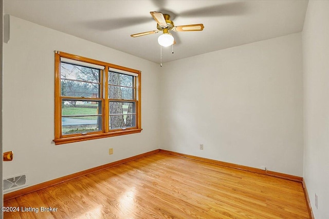 empty room featuring light wood-type flooring and ceiling fan