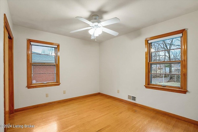 spare room with light hardwood / wood-style flooring, plenty of natural light, and ceiling fan