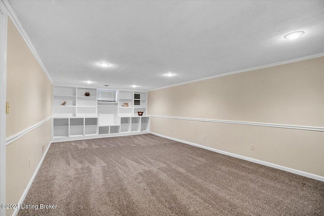 carpeted empty room featuring built in shelves, a textured ceiling, and ornamental molding