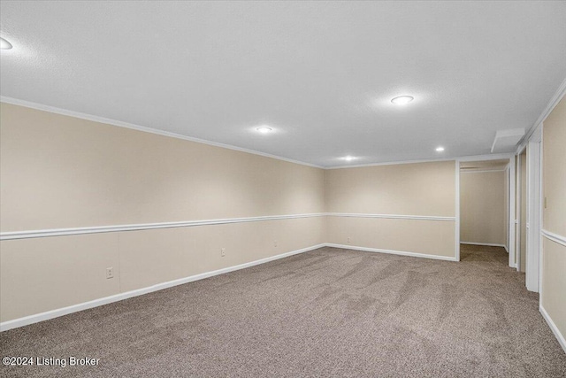 carpeted spare room with crown molding