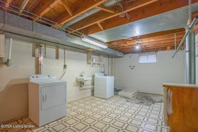 laundry room with separate washer and dryer and sink