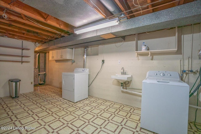 basement featuring separate washer and dryer and sink