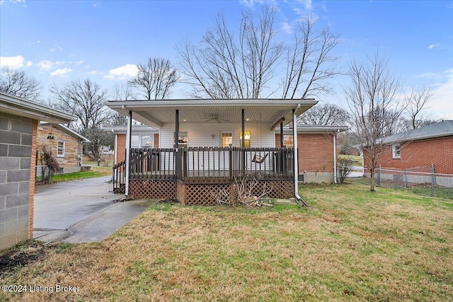 back of property featuring a lawn, ceiling fan, and a porch