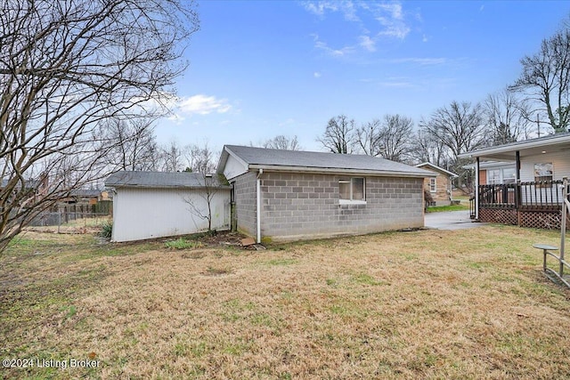 exterior space featuring a lawn and a deck