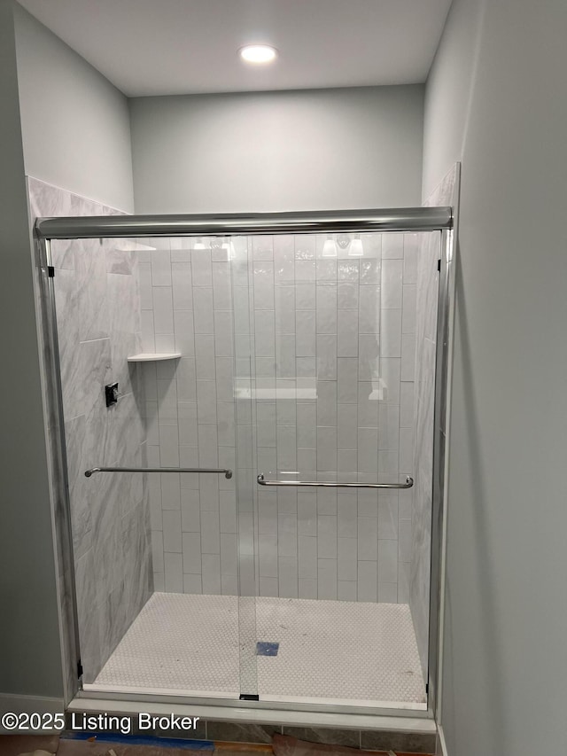 bathroom featuring a shower with shower door