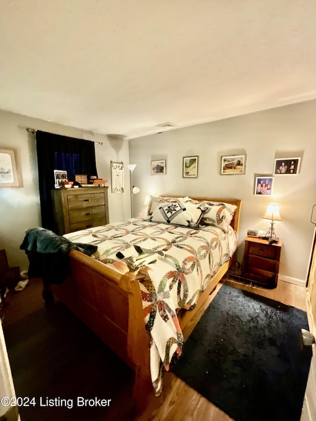 bedroom with hardwood / wood-style flooring