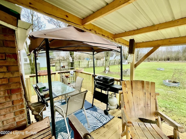 wooden terrace with a gazebo and a yard