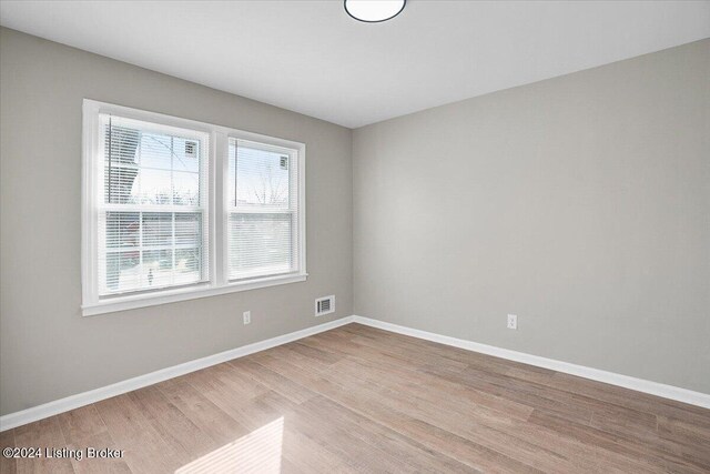 empty room featuring plenty of natural light and light wood-type flooring