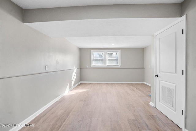 spare room with light wood-type flooring