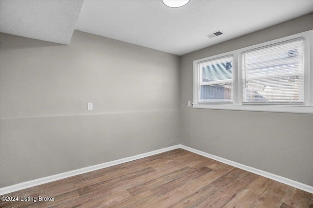 unfurnished room featuring hardwood / wood-style floors