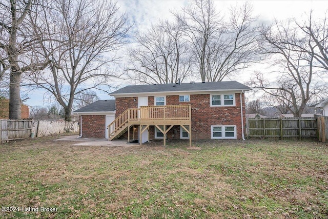 rear view of house featuring a lawn and a wooden deck