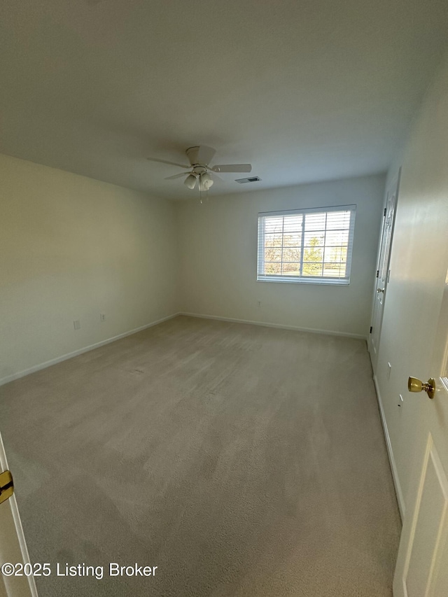 carpeted spare room featuring ceiling fan