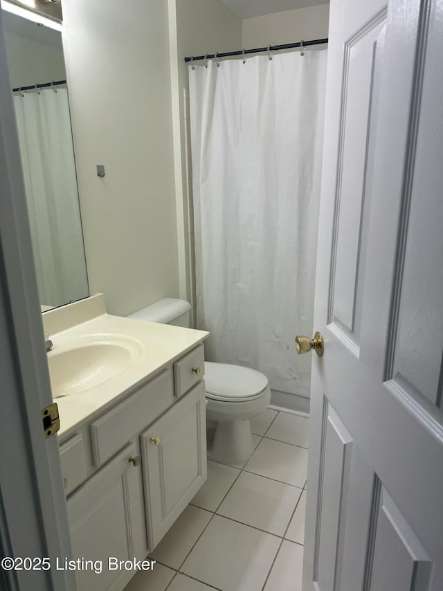 bathroom featuring vanity, toilet, and tile patterned flooring