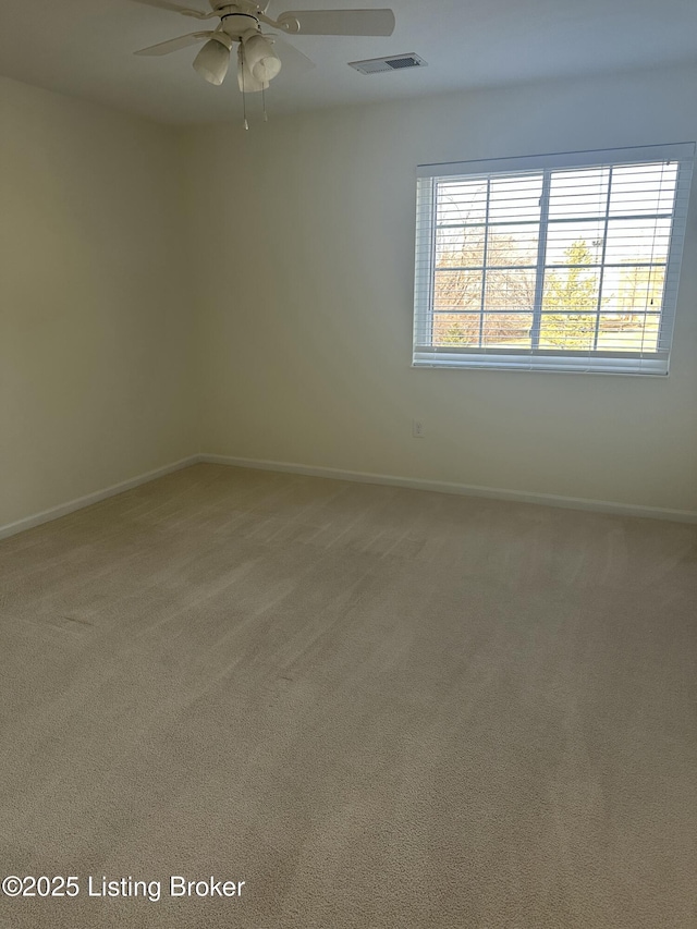 spare room featuring carpet and ceiling fan