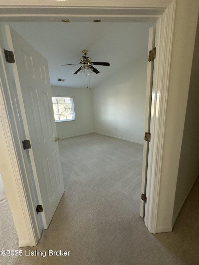 hallway with light colored carpet