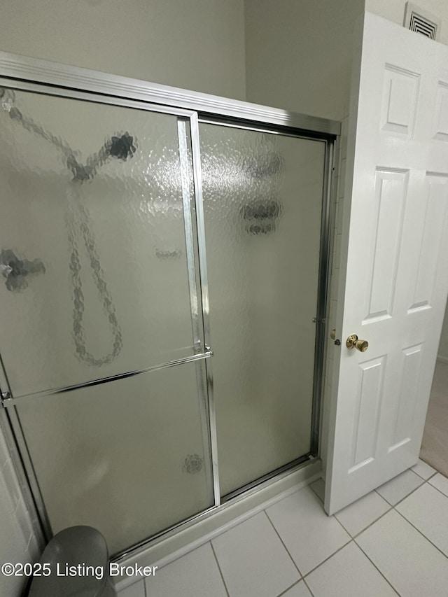 bathroom with walk in shower and tile patterned floors