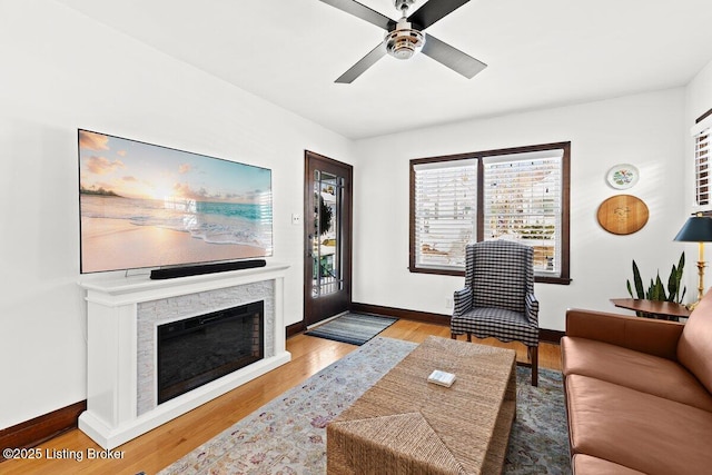 living room with light wood-type flooring and ceiling fan