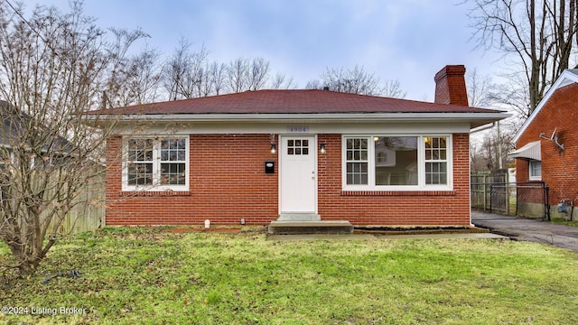 bungalow-style home with a front lawn