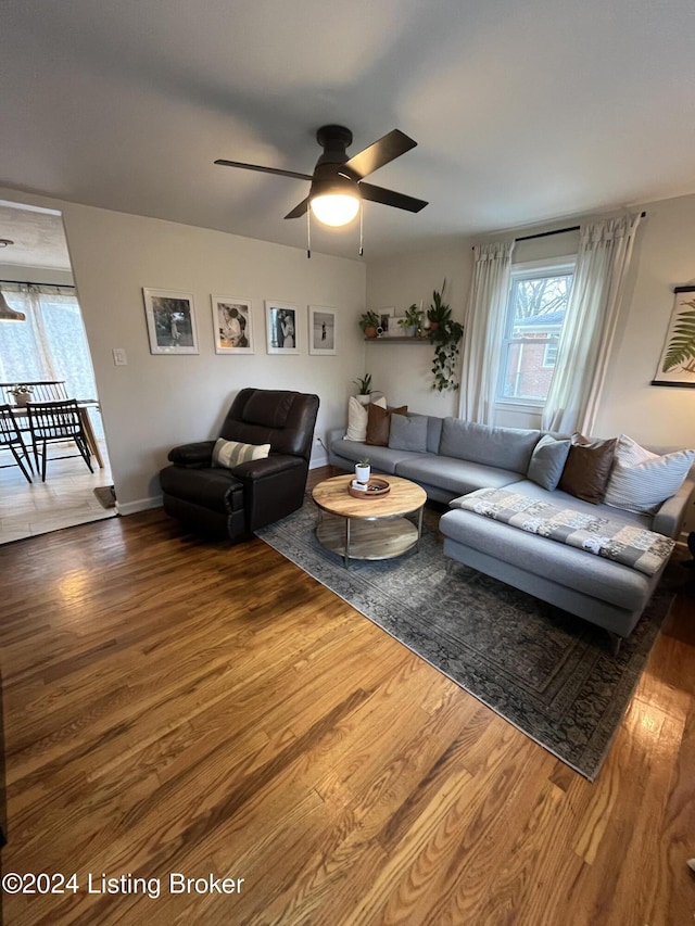 living room with ceiling fan and hardwood / wood-style flooring