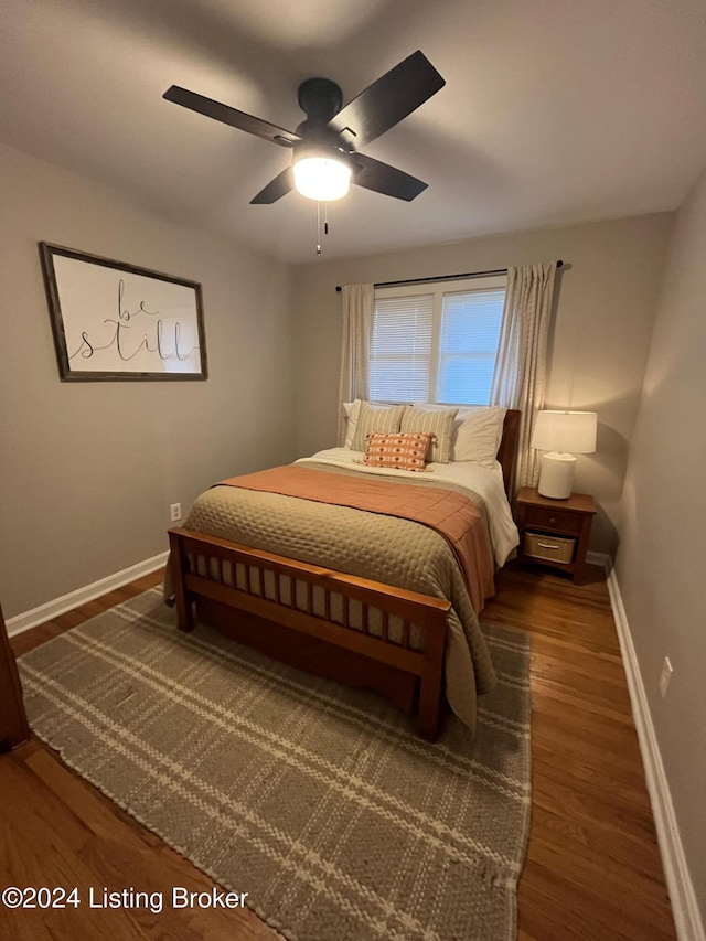 bedroom with ceiling fan and dark hardwood / wood-style floors