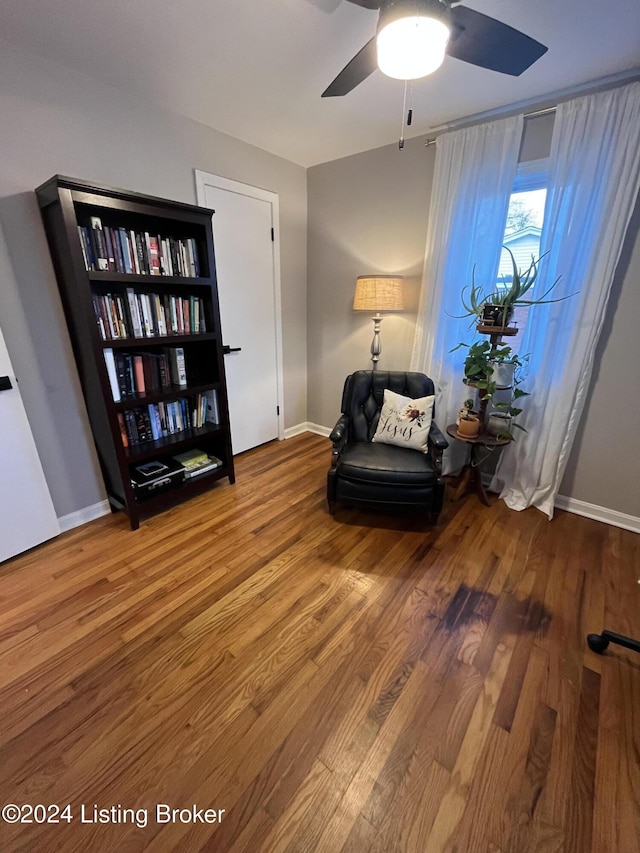 living area with ceiling fan and wood-type flooring