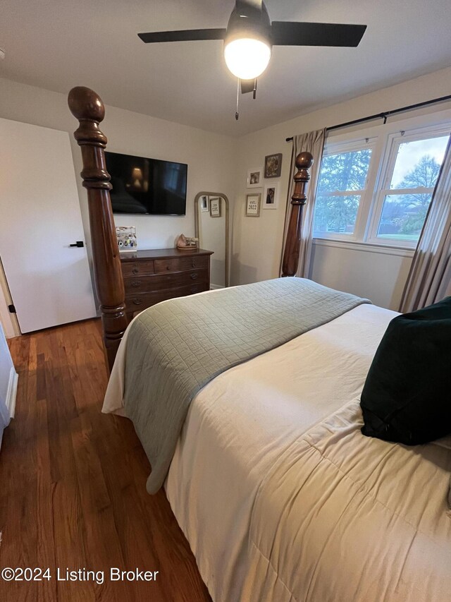 bedroom with ceiling fan and dark wood-type flooring