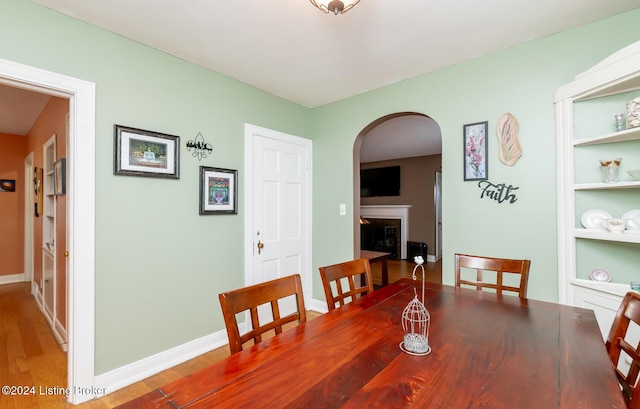 dining room featuring hardwood / wood-style flooring and built in features