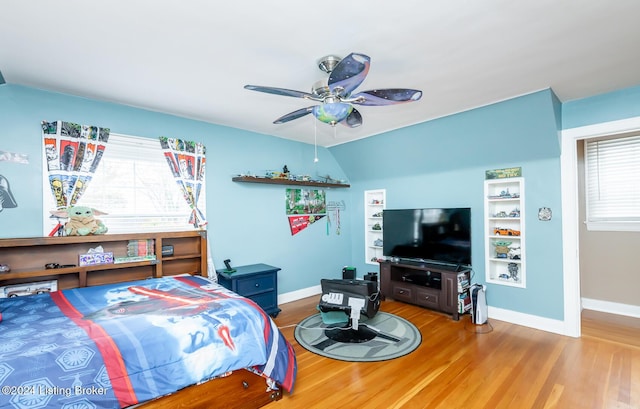 bedroom featuring hardwood / wood-style flooring, ceiling fan, and lofted ceiling