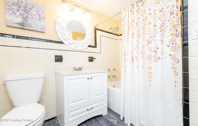 full bathroom featuring vanity, shower / bath combo, toilet, and tile walls