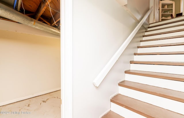 stairway featuring concrete floors