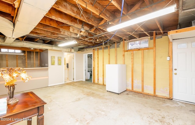 basement featuring white refrigerator