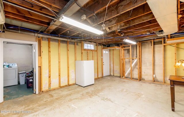 basement with washer / dryer and white refrigerator