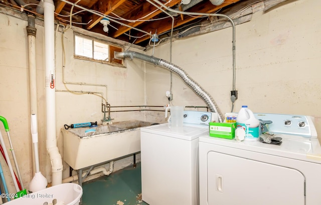 laundry area featuring washer and clothes dryer and sink