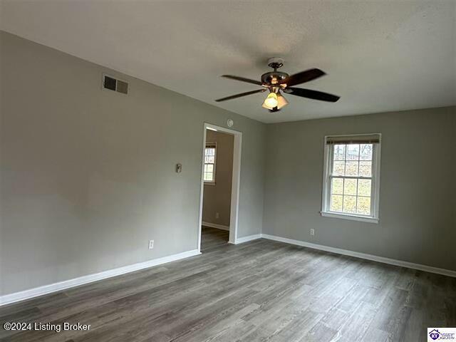 spare room featuring ceiling fan and hardwood / wood-style floors