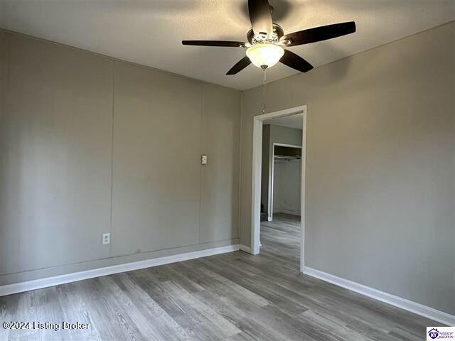 spare room with hardwood / wood-style floors and ceiling fan