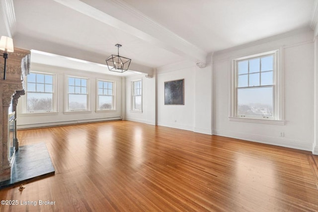 unfurnished living room with a healthy amount of sunlight, beam ceiling, hardwood / wood-style floors, and a baseboard radiator