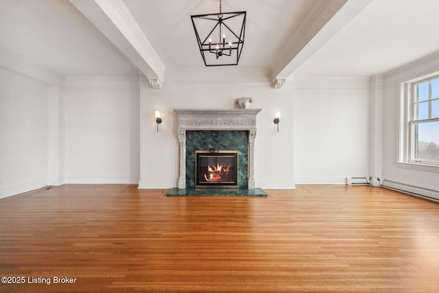 unfurnished living room featuring a high end fireplace, ornamental molding, and hardwood / wood-style flooring