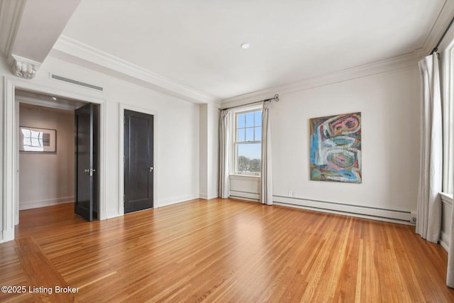 empty room with baseboard heating, ornamental molding, and light hardwood / wood-style flooring