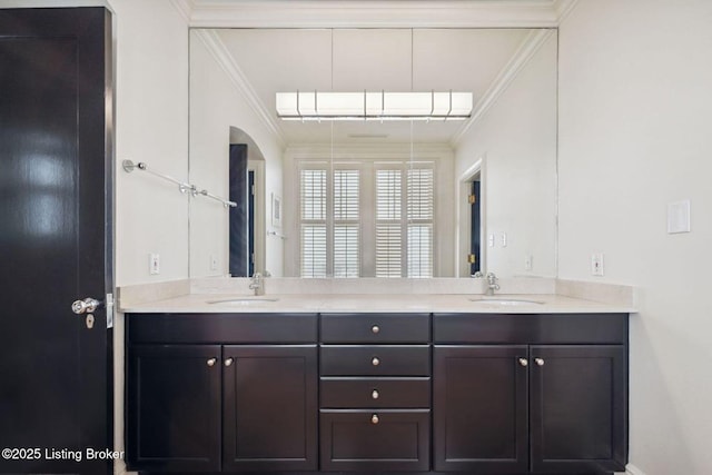 bathroom with crown molding and vanity