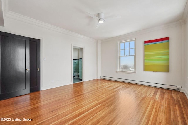 empty room with ceiling fan, crown molding, hardwood / wood-style floors, and a baseboard radiator