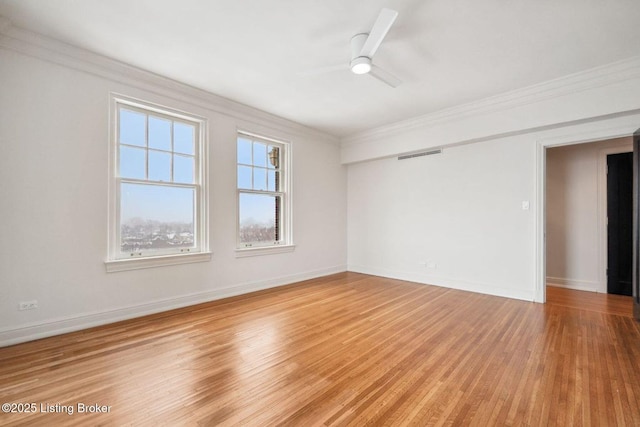 spare room featuring ceiling fan, wood-type flooring, and crown molding