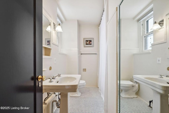 bathroom with toilet, radiator, and curtained shower