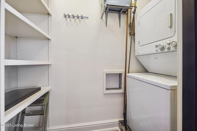 clothes washing area featuring stacked washing maching and dryer