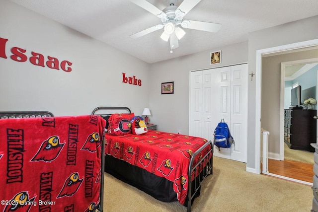 bedroom featuring ceiling fan, a closet, and carpet